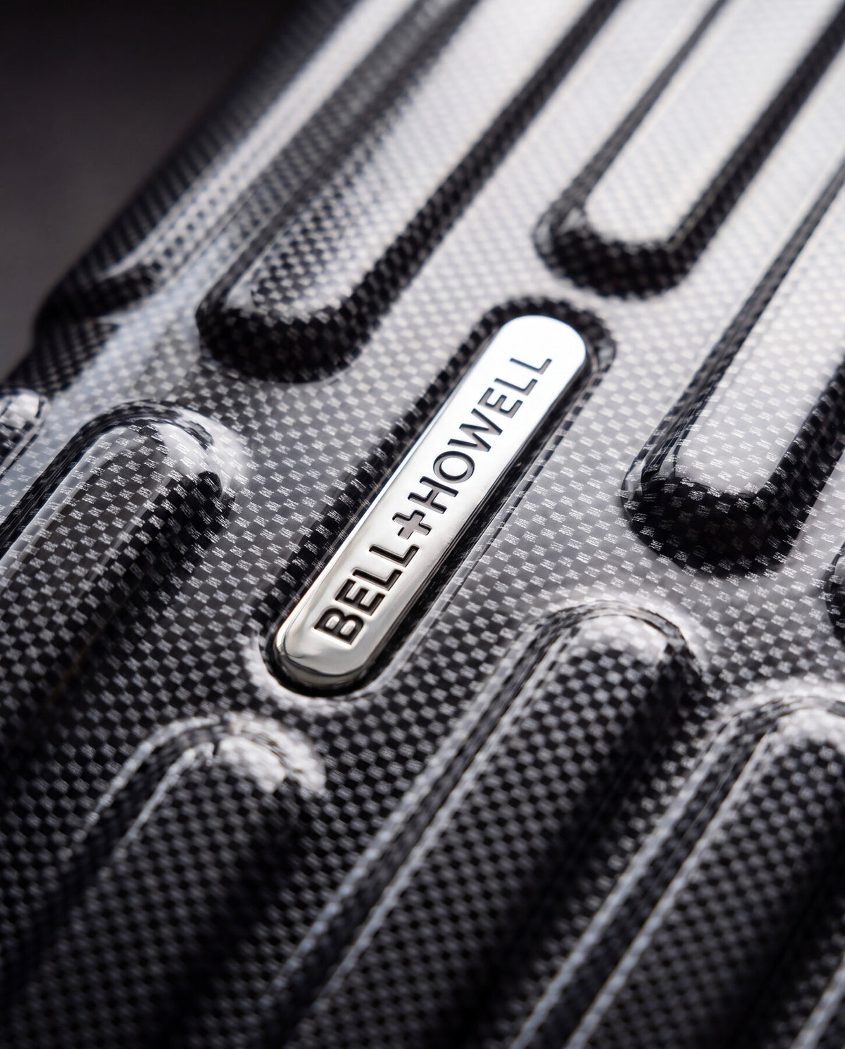 Bell + Howell luggage brand badge close-up