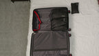 Four included Bell + Howell packing cubes arranged with the open suitcase