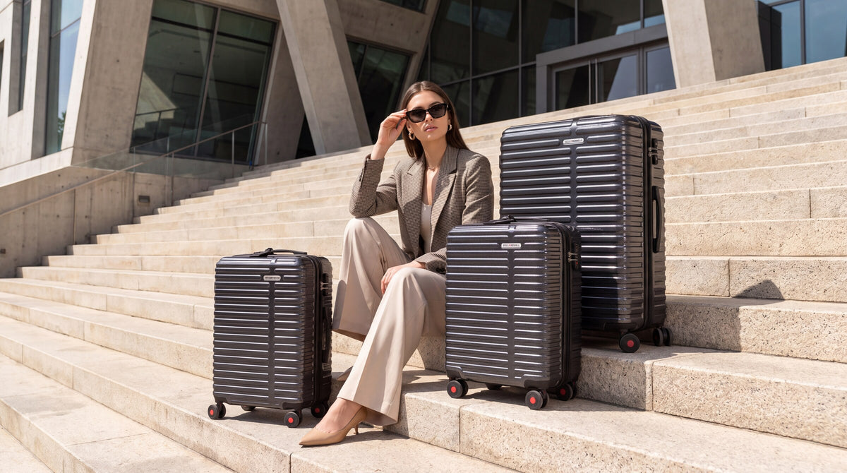 Bell + Howell luggage collection on architectural stone steps
